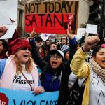 Protestors chant on the National Mall during a demonstration after the inauguration of President Donald Trump. (The Associated Press)