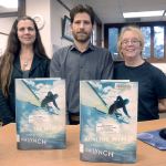 Port Townsend Public Library employees Jeanne Simmons, Keith Darrock and Kit Ward-Crixell stand with copies of &ldquo;Before the Wind,&rdquo; the 2017 Community Read book. (Cydney McFarland/Peninsula Daily News)