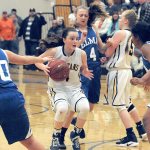 Lonnie Archibald/for Peninsula Daily News Forks&rsquo; Skyler DeMatties drives the key against Elma&rsquo;s McKenzie Neary (20) Kassedy Olson (4) and Olivia Cain (40).