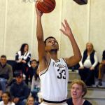 Keith Thorpe/Peninsula Daily News Peninsula&rsquo;s Kevin Baker goes for the layup as Bellevue&rsquo;s Jaden Vollmen, right, looks on during the first half on Saturday in Port Angeles.