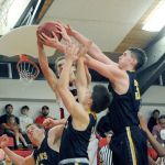 Lonnie Archibald/for Peninsula Daily News Forks&rsquo; Parker Browning left, Cole Baysinger and Marky Adams challenge Neah Bay&rsquo;s Cole Svec for the rebound while Anthony Bitegeko looks on.