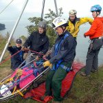 Katie Babcock, a member of the Clallam County Search and Rescue team, in litter, volunteers to be a victim during a rescue drill Wednesday on a waterside slope at the former Clallam County landfill in Port Angeles. Taking the role of rescuers were, from left, Kjel Skov of the Clallam County Fire District No. 3 rescue team, Troy Treaccar of Olympic Mountain Rescue, Mike Sprenger of Fire District No. 3, Kyle Pease of Olympic Mountain Rescue and Kelly Thomas of Clallam Search and Rescue. (Keith Thorpe/Peninsula Daily News)