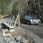 A car makes its way across a recently installed one-lane bridge over a side channel of the Elwha River in Olympic National Park on Thursday after the park service reopened the Elwha Valley to visitors. (Keith Thorpe/Peninsula Daily News)