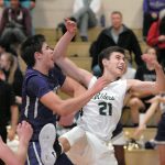 Keith Thorpe/Peninsula Daily News Sequim&rsquo;s Payton Glasser, left, and Port Angeles&rsquo; Kyle Benedict tangle over a rebound during the second quarter on Friday night at Port Angeles High School.