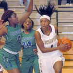 Keith Thorpe/Peninsula Daily News Peninsula&rsquo;s Anaya Rodisha, right, drives through the lane as Edmonds&rsquo; Damaiya Ward, left, and Montasia Brown defend during the second quarter on Saturday night in Port Angeles.