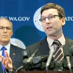 State Attorney General Bob Ferguson, right, talks to reporters as Gov. Jay Inslee, left, looks on Monday in Seattle. Ferguson announced that he is suing President Donald Trump over an executive order that suspended immigration from seven countries with majority-Muslim populations and sparked nationwide protests. (Ted S. Warren/The Associated Press)