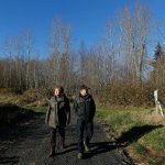 Gennadiy Skachkov and his wife, Olga, walk on the 15-acre parcel of land they own near Ferndale. The couple bought the land as an investment more than 10 years ago but now are finding it difficult to sell to a potential homebuilder, even though it has a well and power in place, due to an October decision by the state Supreme Court that said Whatcom County failed to protect water resources by allowing new wells to reduce flow in streams for fish and other uses. (Ted S. Warren/The Associated Press)