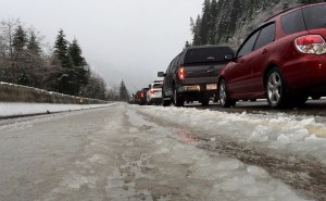In this Dec. 10, 2015, photo, vehicles along eastbound Interstate 90 heading up Snoqualmie Pass are stopped in snow and slush during a road closure in Washington state. (Ted S. Warren/The Associated Press)