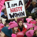 A woman holds a sign amidst a sea of pink caps before a women&rsquo;s march Saturday in Seattle. Women across the Pacific Northwest marched in solidarity with the Women&rsquo;s March on Washington and to send a message in support of women&rsquo;s rights and other causes. (Elaine Thompson/The Associated Press)
