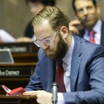 Senate Democratic floor leader Marko Liias, D-Mukilteo, reads in the Legislative Manual as he sits at his desk Friday in Olympia. (Ted S. Warren/The Associated Press)