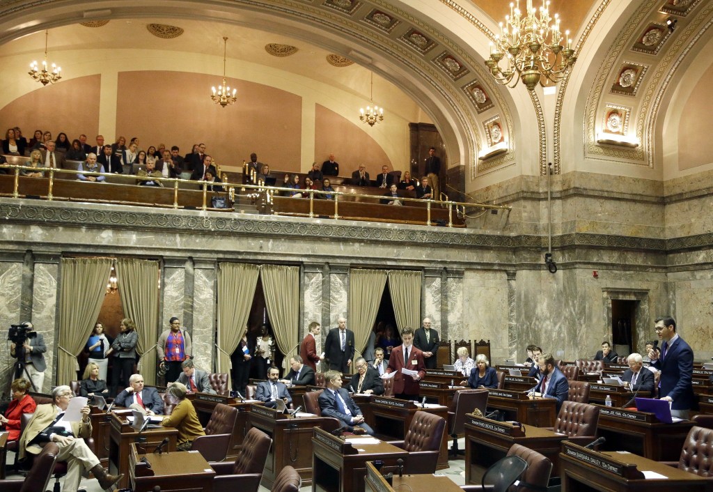 Senate Republican floor leader Joe Fain, R-Auburn, stands at right as he makes a point on the Senate floor Friday in Olympia. Fain was the only Republican present as senators debated whether to vote on the &ldquo;levy cliff&rdquo; bill, which would delay a reduction in the amount of money school districts can collect though property taxes. (Ted S. Warren/The Associated Press)