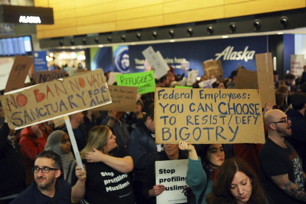 More than 1,000 people gather Saturday at Seattle-Tacoma International Airport to protest President Donald Trump&rsquo;s order that restricts immigration to the U.S. (Genna Martin/seattlepi.com via AP)