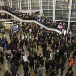 More than 1,000 people gather Saturday at Seattle-Tacoma International Airport to protest President Donald Trump&rsquo;s order that restricts immigration to the U.S. (Genna Martin/seattlepi.com via AP)