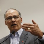 Gov. Jay Inslee speaks to the media in the Airport Office Building at Seattle-Tacoma International Airport on Saturday. (Logan Riely/The Seattle Times via AP)