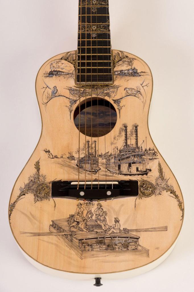 A guitar decorated by Charlie Crain. (Juan de Fuca Foundation)