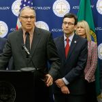 Gov. Jay Inslee speaks Monday during a news conference at the Capitol in Olympia to announce that he and Attorney General Bob Ferguson, third from left, have proposed legislation to abolish the death penalty in Washington state. (Ted S. Warren/The Associated Press)