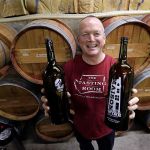 Winemaker Paul Beveridge displays the type of wine &ldquo;growler&rdquo; bottle he would like to see available to consumers, at his winery in Seattle on Tuesday. (Elaine Thompson/The Associated Press)