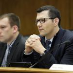 State Sen. Joe Fain, R-Auburn, right, listens to testimony during a Senate hearing at the Capitol on Thursday in Olympia. (Ted S. Warren/The Associated Press)