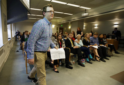 Jaxon Owens, 17, left, editor-in-chief of the Viking Vanguard student newspaper at Puyallup High School, walks to speak during a Senate hearing at the Capitol on Thursday in Olympia. (Ted S. Warren/The Associated Press)