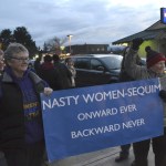Kathi White and Donna Maclean hold one of the few signs up at the women&rsquo;s rights rally in downtown Sequim last Saturday. Maclean said their sign is a response to President Donald Trump calling his opponent Hillary Clinton a &ldquo;nasty woman&rdquo; at a debate. (Matthew Nash/Olympic Peninsula News Group)