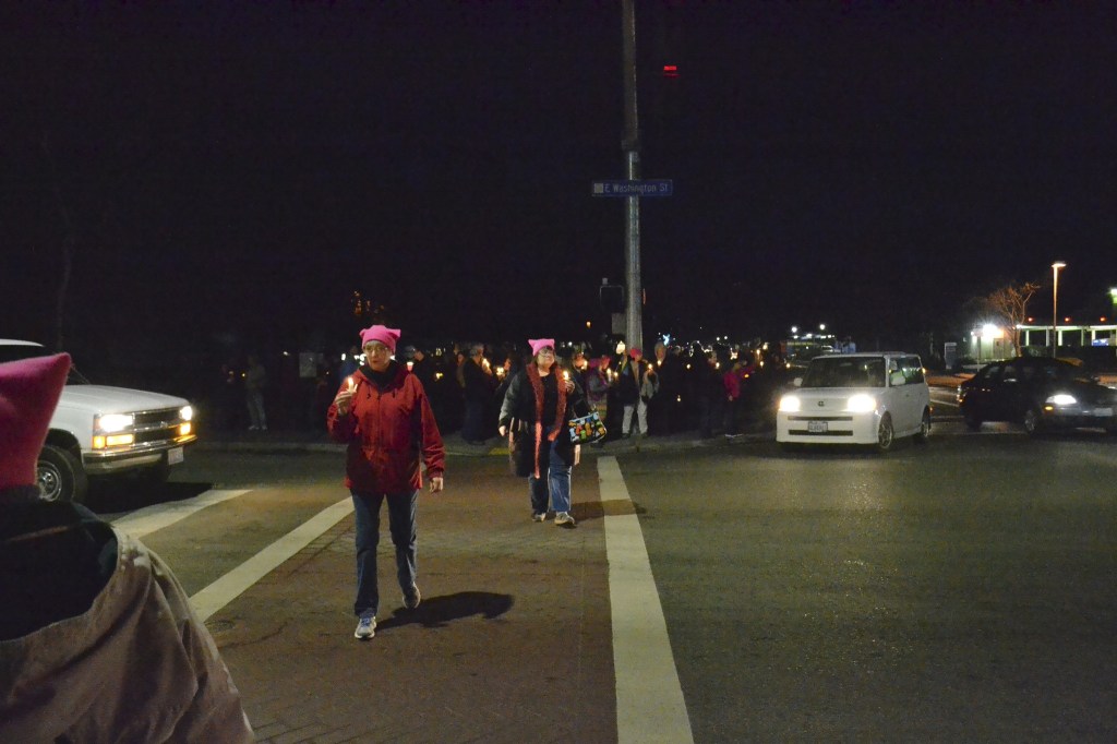 People gather last Saturday at the southeast corner of Washington Street and Sequim Avenue for women&rsquo;s rights. Organizers estimate more than 100 people attended. (Matthew Nash/Olympic Peninsula News Group)