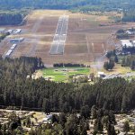 Trees in Lincoln Park in Port Angeles stand in the approach to Runway 26 at William R. Fairchild International Airport in July 2011. (Keith Thorpe/Peninsula Daily News)