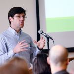 Caleb Banta-Green, a researcher at the University of Washington&rsquo;s Alcohol and Drug Abuse Institute, talks to about 300 people during the Olympic Community of Health opioid summit Monday. (Jesse Major/Peninsula Daily News) ​