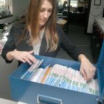 Clallam County Auditor Shoona Riggs looks over a box containing 125 unopened general election ballots that were overlooked during last November&rsquo;s count. (Keith Thorpe/Peninsula Daily News)