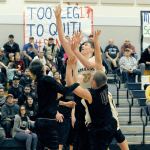 Lonnie Archibald/for Peninsula Daily News Forks&rsquo; Marky Adams scores over Montesano&rsquo;s Nick Chapman (left) and Seth Dierkop (41) Tuesday night in Forks during this critical league matchup. The Spartans held on and won 67-62 over the Bulldogs.