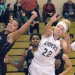 Keith Thorpe/Peninsula Daily News Port Angeles&rsquo; Natalie Steinman, right, fights for a rebound with Olympic&rsquo;s Kiki Mitchell, left, as Olympic&rsquo;s Kahlishia Grant looks on during the second quarter on Tuesday at Port Angeles High School.