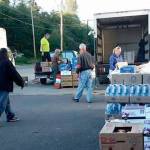 Officials with the Forks Food Bank, Sequim Food Bank, Salvation Army, Port Angeles Food Bank and Serenity House load supplies from Food Lifeline on Jan. 31 at the Port Angeles Food Bank. Different agencies gather there weekly to pick up supplies and distribute abundant items. (Jessica Hernandez)