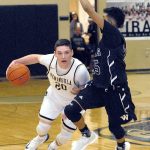 Keith Thorpe/Peninsula Daily News Peninsula&rsquo;s Cole Rabedeaux, left, drives past Whatcom&rsquo;s Dante Lewis in first-half action on Wednesday in Port Angeles.