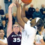 Keith Thorpe/Peninsula Daily News Peninsula&rsquo;s Jenise McKnight, right, takes the layup past the defense of Whatcom&rsquo;s Lindsey Honeycutt in third-quarter action on Wednesday in Port Angeles.