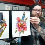 Tattoo artist Russ Brown of Mark&rsquo;d Body Art in Port Angeles displays samples of his work on Tuesday. (Keith Thorpe/Peninsula Daily News)