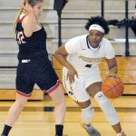 Keith Thorpe/Peninsula Daily News Peninsula&rsquo;s Jenise McKnight slips past the defense of Everett&rsquo;s Uju Chibuogwu in the second quarter on Saturday in Port Angeles.
