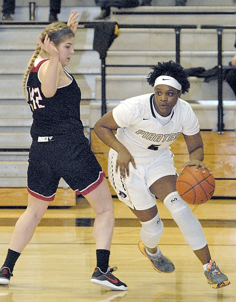 Keith Thorpe/Peninsula Daily News                                Peninsula&rsquo;s Jenise McKnight slips past the defense of Everett&rsquo;s Claire Fyfe in the second quarter on Saturday in Port Angeles.