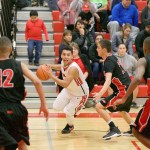 Steve Mullensky/for Peninsula Daily News Nea Bay, in black, and Port Townsend, inwhite jerseys, represent the opposite ends of the spectrum when it comes to the effect of the WIAA&rsquo;s new RPI system. Pictured are Port Townsend&rsquo;s Jacob Boucher and Neah Bay&rsquo;s Sean Bitegeko (12), Kendrick Doherty (22), and Anthony Bitegeko (3) during the Crush in the Slush at Port Townsend High School in December.