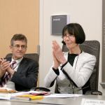 Jefferson Healthcare Commissioner Jill Buhler and hospital CEO Glenn Mike Glenn applaud the hospital commissioners decision to begin the hospitals affiliation with Discovery Behavioral Health at a meeting Wednesday. (Cydney McFarland/Peninsula Daily News)