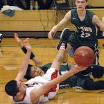 Keith Thorpe/Peninsula Daily News Neah Bay&rsquo;s Cameron Moore, front, and Cedar Park Christian&rsquo;s Sam Yaranon scramble for a loose ball as Cedar Park&rsquo;s Jacob Schley looks on in the second quarter on Thursday at Port Angeles High School.