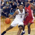 Keith Thorpe/Peninsula Daily News Peninsula&rsquo;s Darrion Daniels, left, sweeps around Everett&rsquo;s Gio Jackson in first half play on Saturday night in Port Angeles.