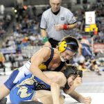 Lonnie Archibald/for Peninsula Daily News Forks&rsquo; Garrison Schumack, in top position, defeats Ethan Newman of Deer Park to place third in the 1A division&rsquo;s 145-pound class at Mat Classic XXIX in the Tacoma Dome.