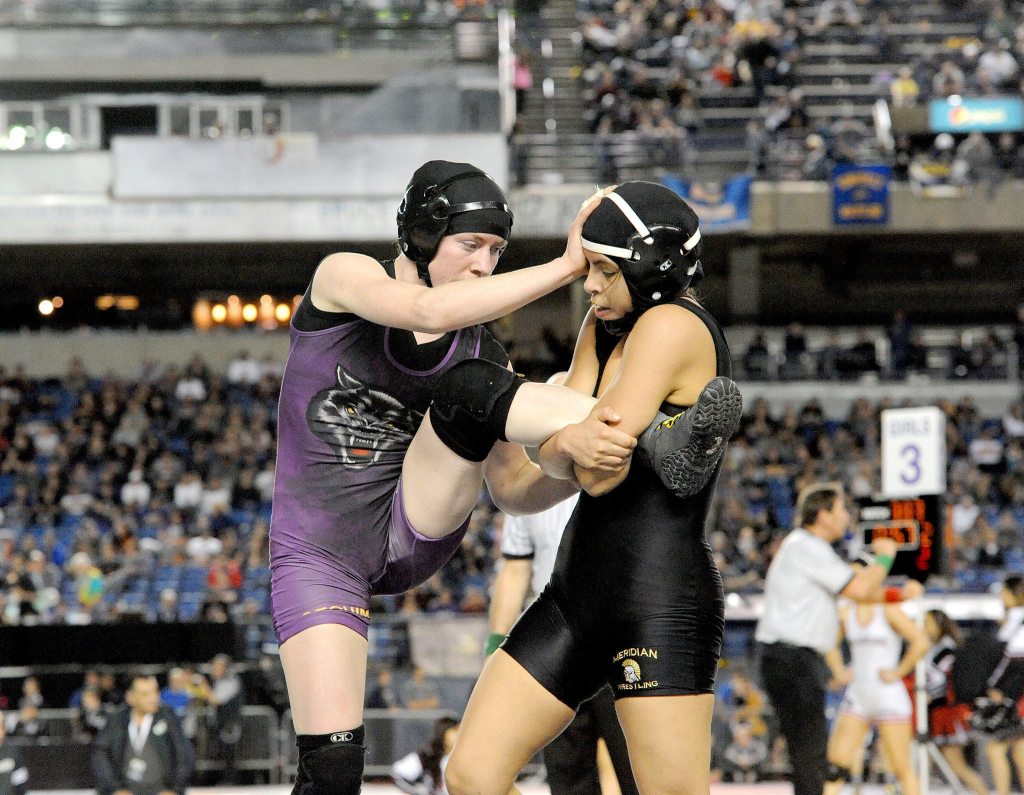 Lonnie Archibald/for Peninsula Daily News Kiara Pierson of Sequim (left) beat De La Cruz of Meridian for third place in the girls 120-pound 2A class at the Mat Classic XXIX.