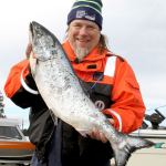 Dave Logan/for Peninsula Daily News Tony Beam of Hansville shows off the winning salmon he caught in the Olympic Peninsula Salmon Derby on Friday. His 15.25-pound fish was caught near Port Townsend first thing Friday morning weighed in at 15.25 pounds. Hansville won $10,000 from the Gardiner Salmon Derby Association.