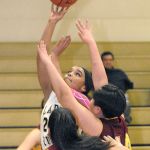 Keith Thorpe/Peninsula Daily News Clallam Bay&rsquo;s Atokena Abe, top, makes a layup over the defense of Lopez Island&rsquo;s Anna Velazquez, front, and Dariya Begman during a playoff game played Feb. 14 in Port Angeles.