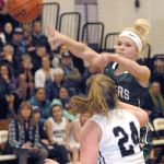 Keith Thorpe/Peninsula Daily News Port Angeles&rsquo; Natalie Steinman, top, passes past Sequim&rsquo;s Madison Green during the Roughriders&rsquo; win in Sequim earlier this season.