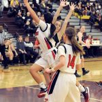 Lonnie Archibald/for Peninsula Daily News Neah Bay&rsquo;s Vonte Aguirre drives past Naselle&rsquo;s Taylor Ford for a basket during the Red Devils 58-39 Class 1B state regional win at Mount Tahoma High School on Saturday. Looking on for Naselle is Lilli Zimmerman (14) and the Red Devils&rsquo; Cheyenna Svec (14).