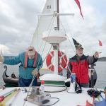 Race officers Dave Burrows and Myron Gauger track the wind direction in order to adjust the start line of the annual Shipwrights Regatta in Port Townsend Bay on Saturday. (Cydney McFarland/Peninsula Daily News)
