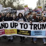 People hold a banner as they take part in a protest march Saturday in London against U.S. President Donald Trump&rsquo;s ban on travelers and immigrants from seven predominantly Muslim countries entering the U.S. Thousands of protesters have marched on Parliament in London to demand that the British government withdraw its invitation to U.S. President Donald Trump. (Matt Dunham/The Associated Press)