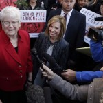 In this Nov. 15, 2016, photo, Barronelle Stutzman, left, a Richland florist who was fined for denying service to a gay couple in 2013, smiles as she is surrounded by supporters after a hearing before the state Supreme Court in Bellevue. (Elaine Thompson/The Associated Press)