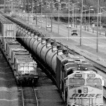 In this July 27, 2015, photo, traffic passes one of two mile-long oil trains parked near the King County Airport in Seattle. (Elaine Thompson/The Associated Press)